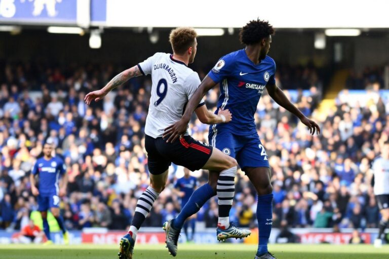 Two soccer players competing for ball during Premier League match