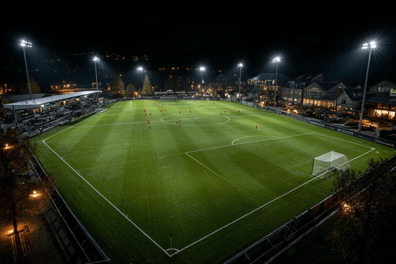 Illuminated soccer field with players during evening game